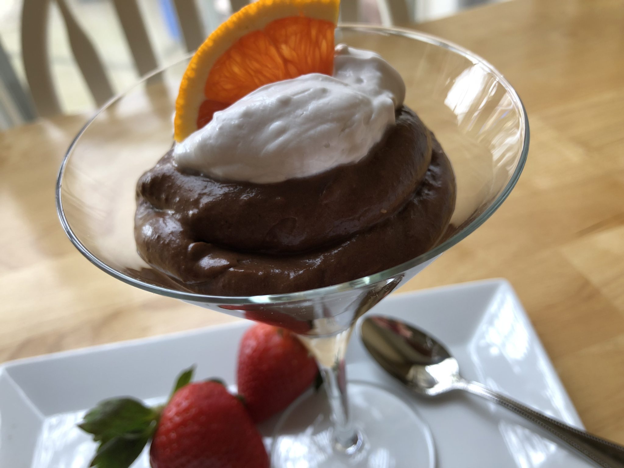 healthy dark chocolate mousse recipe garnished with strawberries and orange