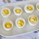 deviled eggs recipe filled on white platter